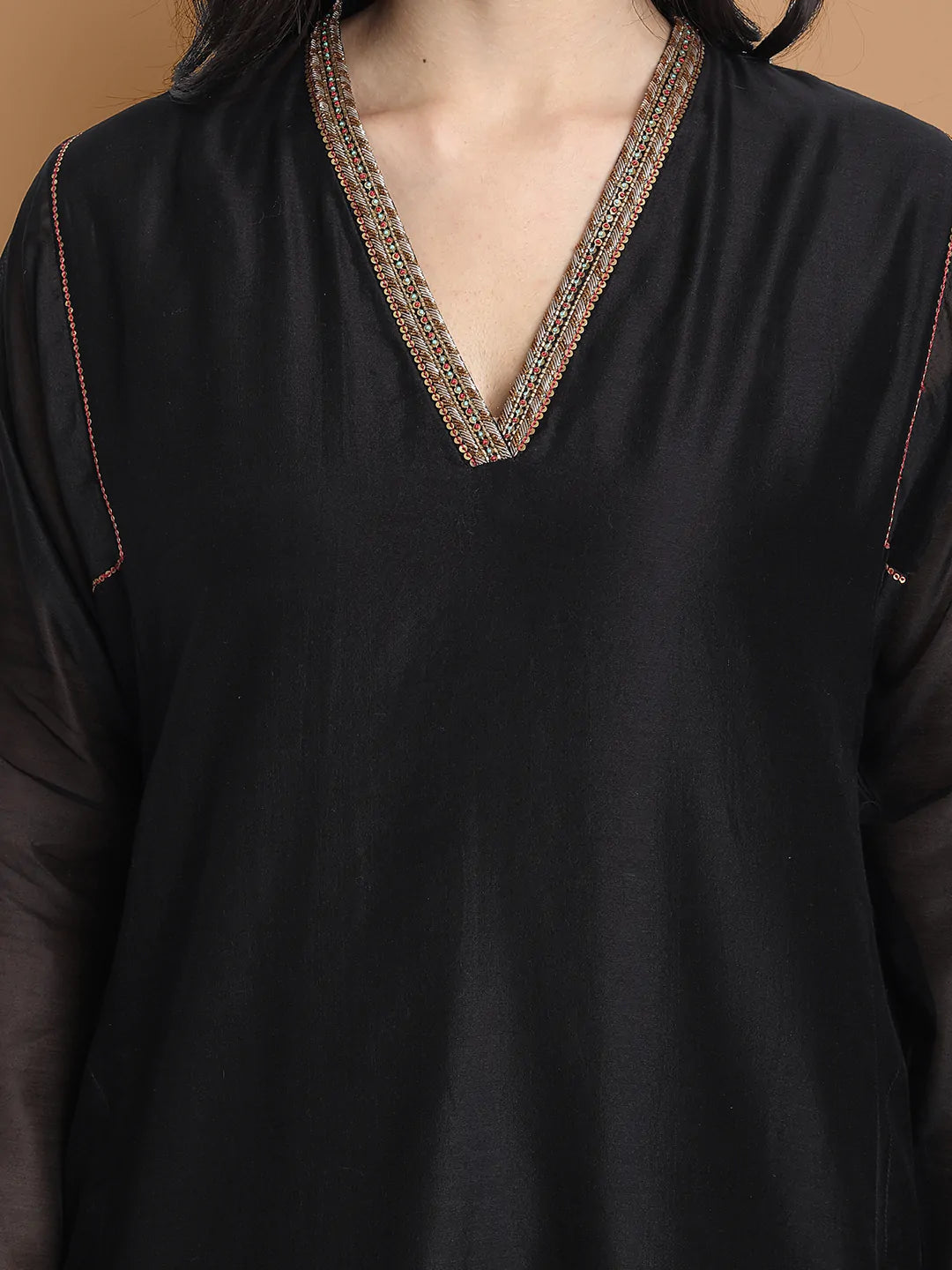 Yarn dyed chanderi kurta accentutated with hand embroidery at the neck area and armhole and cuff, paired with cotton pencil pant