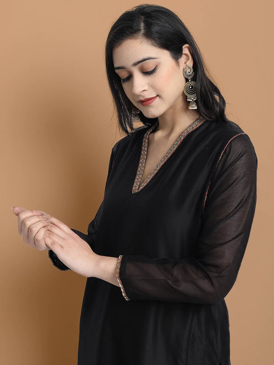 Yarn dyed chanderi kurta accentutated with hand embroidery at the neck area and armhole and cuff, paired with cotton pencil pant