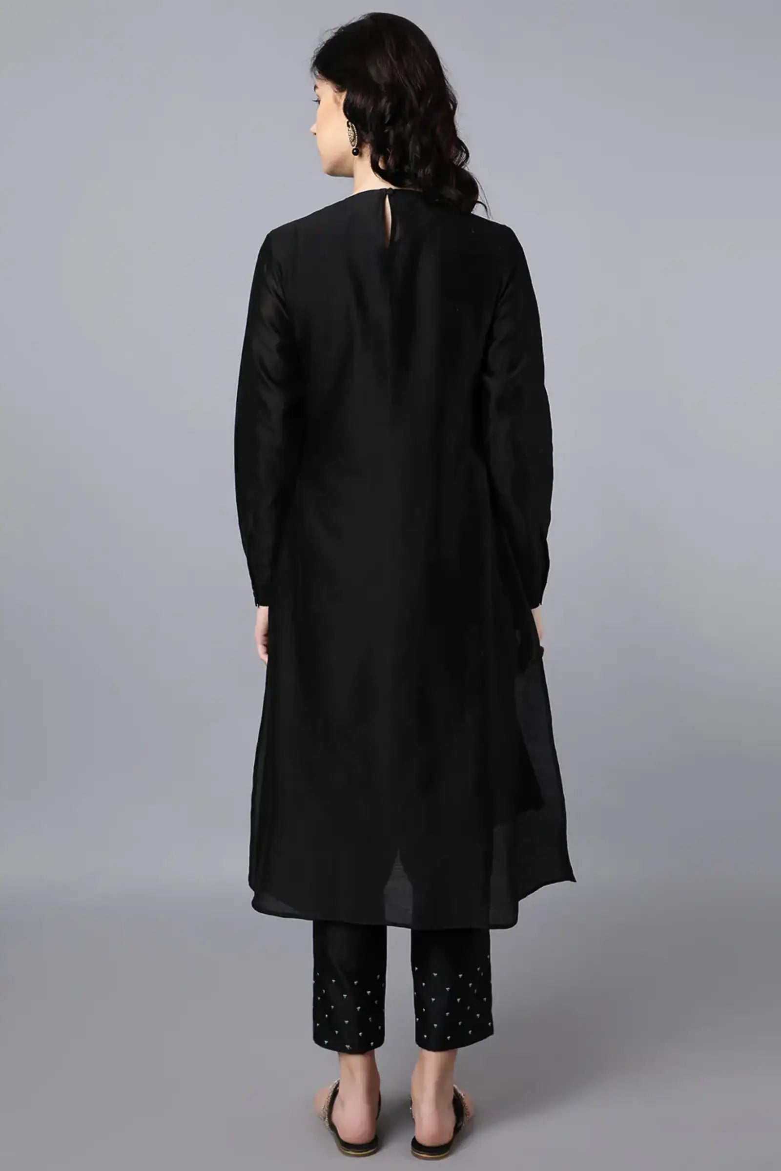Chanderi Asymetric Kurta Black with hand embroidery on neck paired with pencil pants.