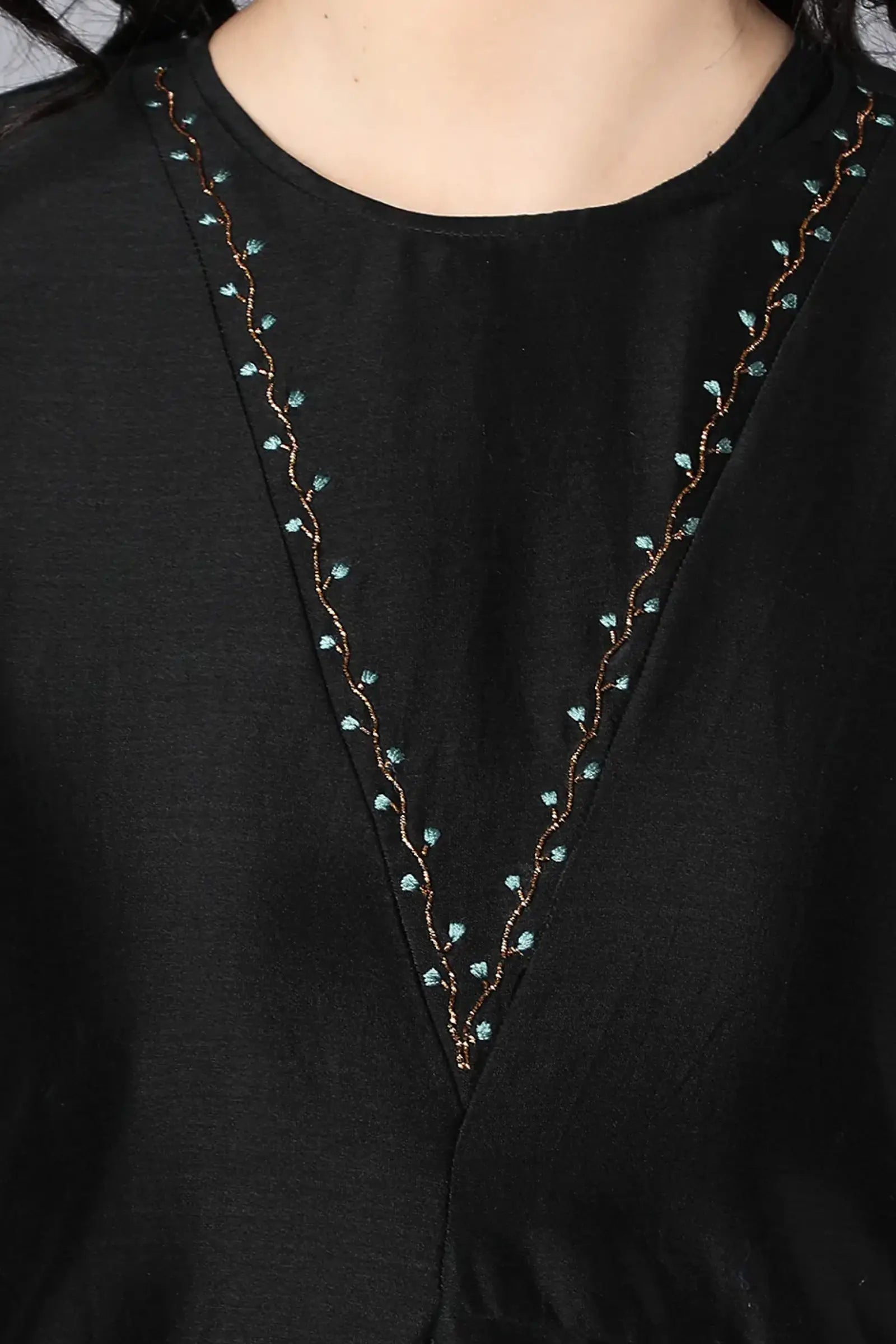 Chanderi Asymetric Kurta Black with hand embroidery on neck paired with pencil pants.