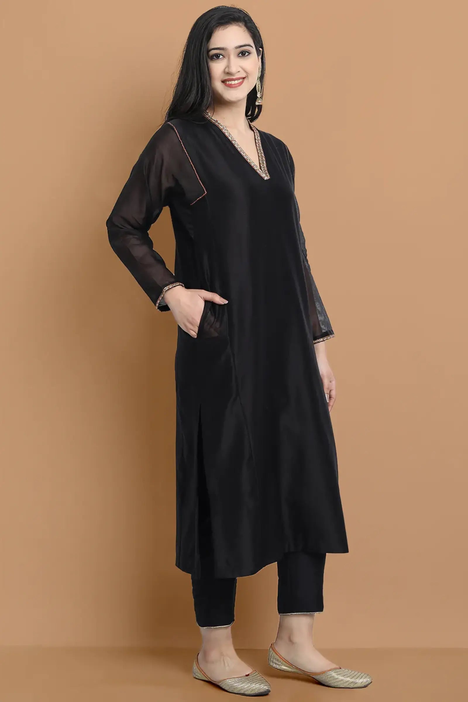Yarn dyed chanderi kurta accentutated with hand embroidery at the neck area and armhole and cuff, paired with cotton pencil pant
