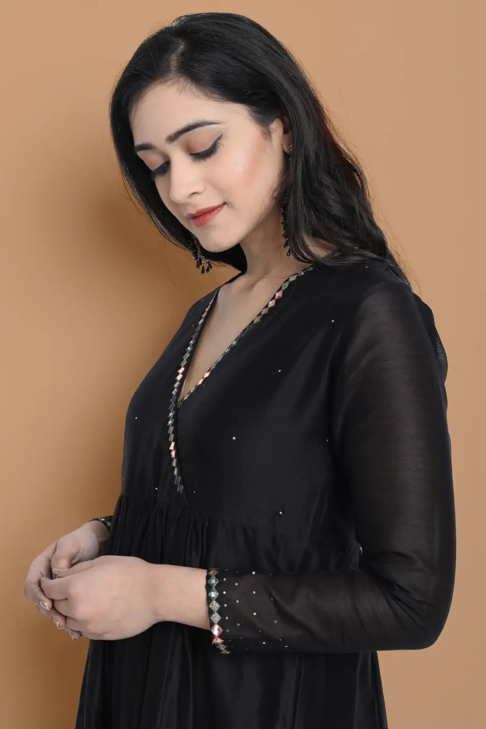 Black silk chanderi Dress Accentuated with Exquisite hand embroidery signifing beauty is in the detailing.