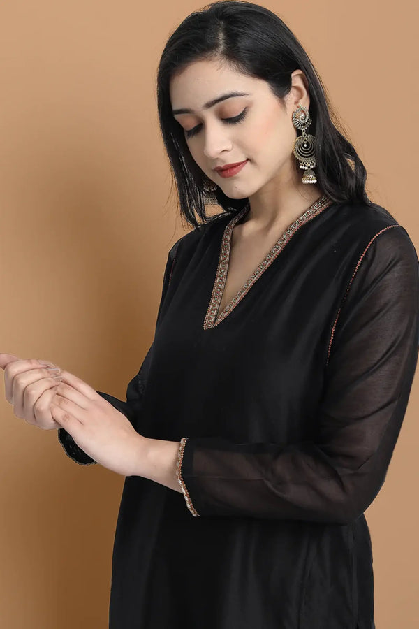 Yarn dyed chanderi kurta accentutated with hand embroidery at the neck area and armhole and cuff, paired with cotton pencil pant