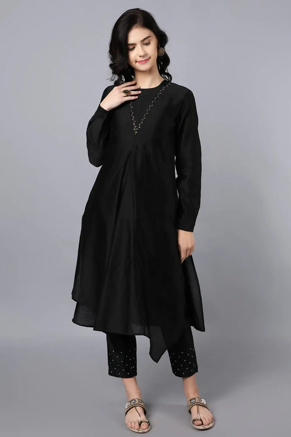Chanderi Asymetric Kurta Black with hand embroidery on neck paired with pencil pants.